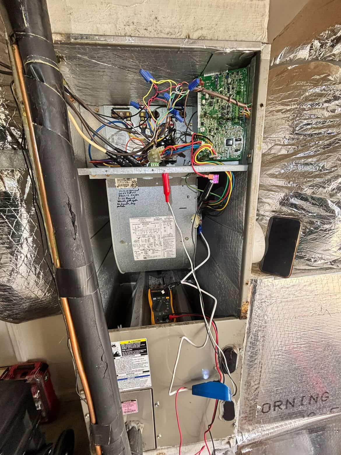 Opened air handler revealing a wiring issue mid-diagnosis