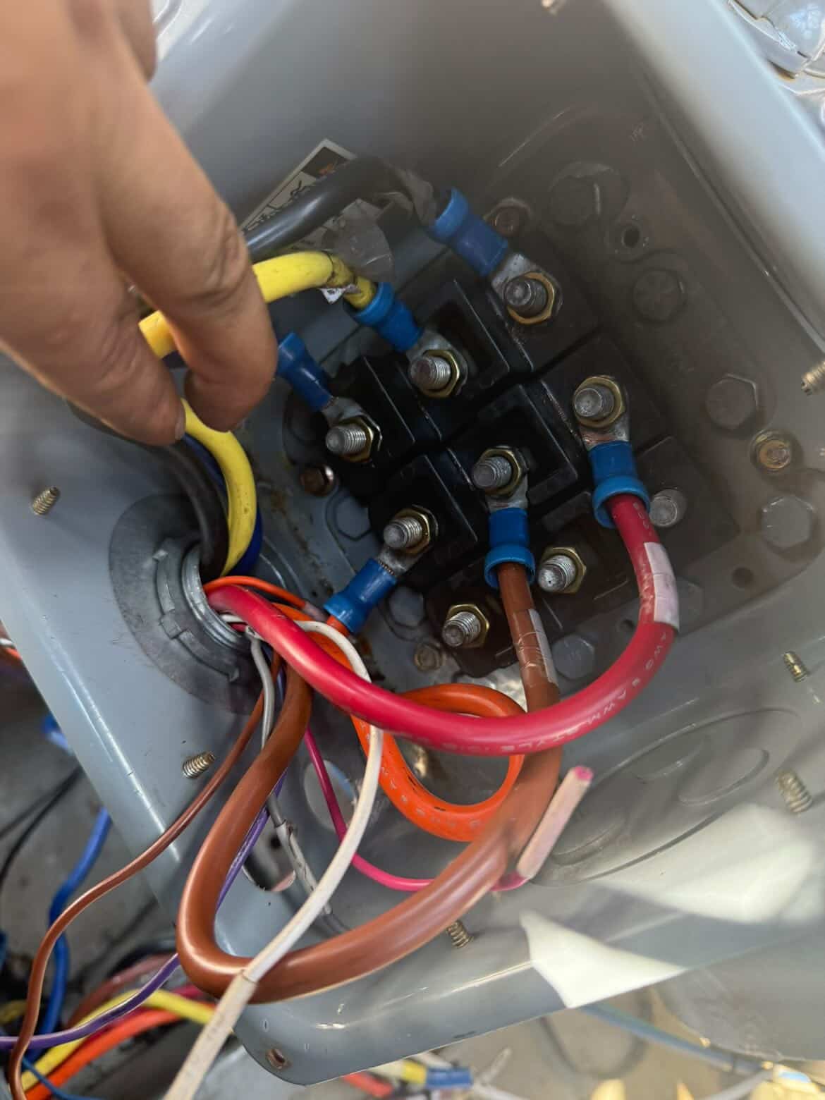 Inspecting and tightening contactor wiring during a tune-up
